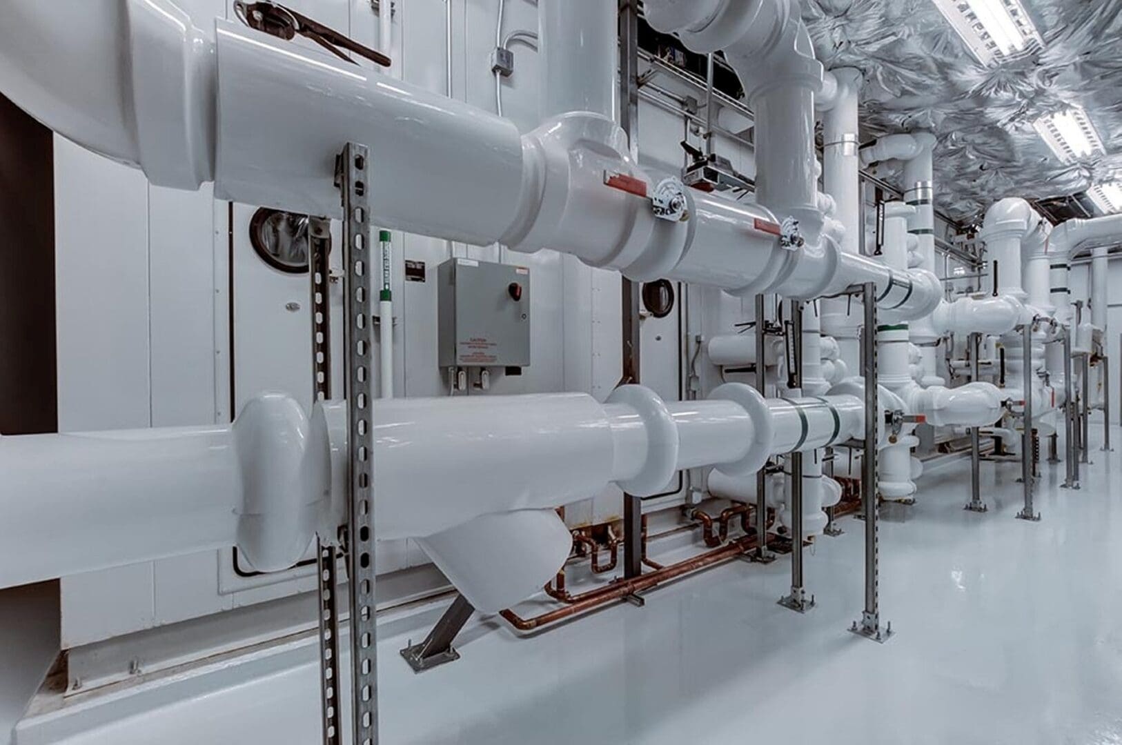 A white pipe system in a building with pipes.